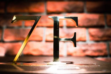 Otel bölgesindeki duvarın arkasında 3D altın harfler var..