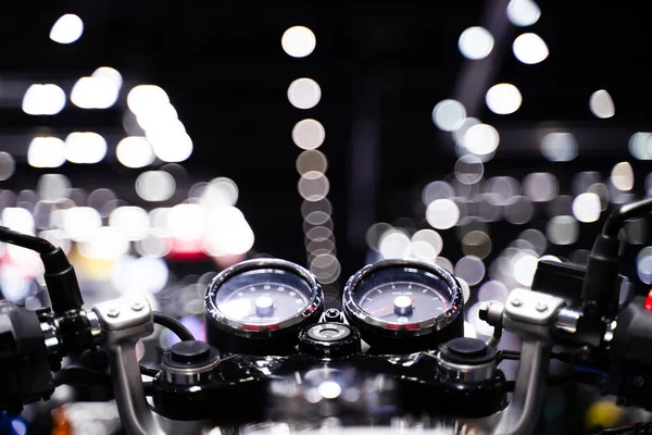 View above the handlebars of a vintage motorcycle. bokeh light background.
