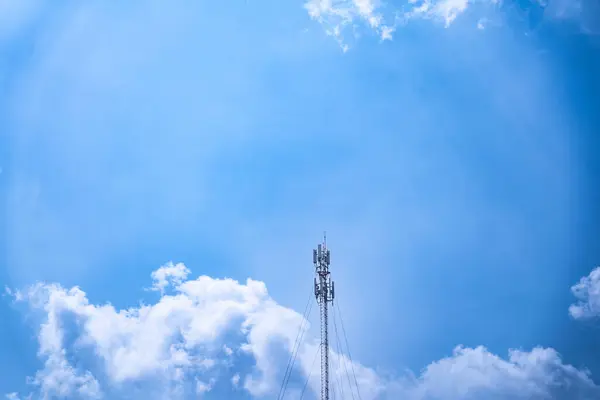 stock image Telecommunications tower, transmitter, wireless communication antenna 5G cellular network, global connectivity In the background, the sky is bright.