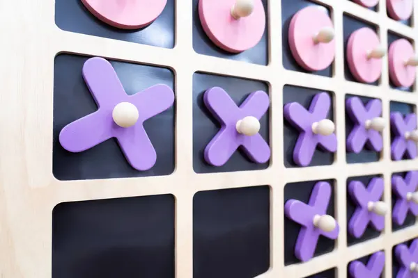 stock image Close-up of XO, wooden board, XO game, psychology, small wooden toy, pastel colors.