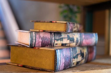 Old books on the shelf, vintage collection of books, blurred background. clipart