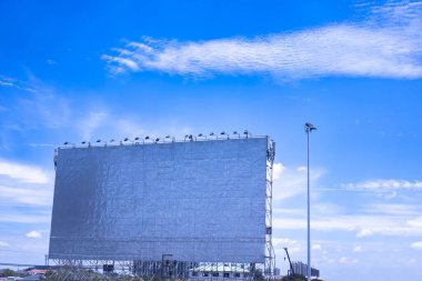 A large empty billboard on a bright morning sky background. clipart