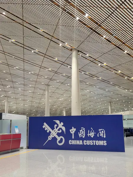 Üzerinde Çin Gümrüğü kelimelerini gösteren büyük mavi bir tabela havaalanı tesisindeki gümrük bölgesini gösteriyor.
