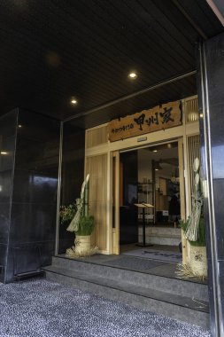 Fujiyama, Japonya - 2 Ocak 2025: Huzurlu bir akşamda geleneksel dekorasyonlarla süslenmiş sakin bir Japon restoranına giriş. Yüksek kalite fotoğraf