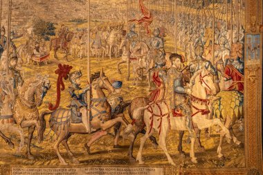 Bu sanat eseri, bir grup adamın geniş ve açık alanda ustalıkla ata bindiği canlı ve dinamik bir sahneyi tasvir ediyor.