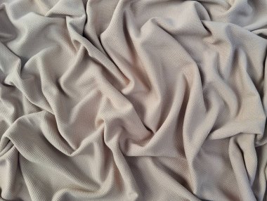 Açık kahverengi ipek kumaş arka plan. Kumaşın yüzeyinde güzel dalgalı yumuşak kıvrımlar. Tasarım için kopyalama alanı olan Teal zarif arkaplan.