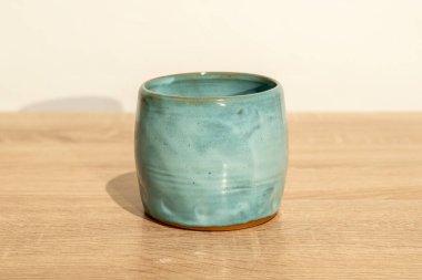 Ahşap bir masada el yapımı seramik. Beyaz duvar arka planı. ürün fotoğrafçılığı.