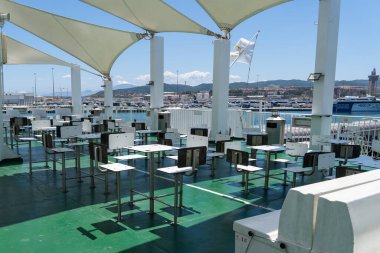 The terrace canteen of a ferry still at pier. High quality photo clipart