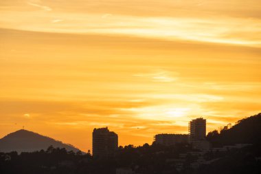 A city in the mountains at sunset, high building. High quality photo clipart