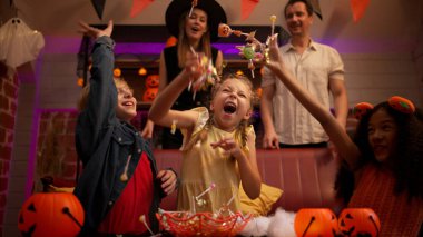 Aileler ve çocuklar cadılar bayramı partisinin tadını çıkarıyorlar.