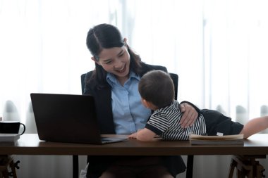 Bir iş annesi ve onun görevi çalışırken çocuklarına bakmaktır.