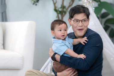 Baba ve oğul işten eve döndükten sonra birlikte oynuyorlar.