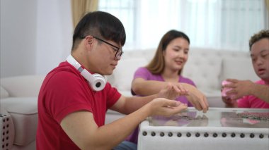 Üç kardeş domuz kumbarasına yatırarak tasarruf ediyorlar, bu ailelerin çocuklarına para biriktirmeyi öğrettikleri bir aktivite.