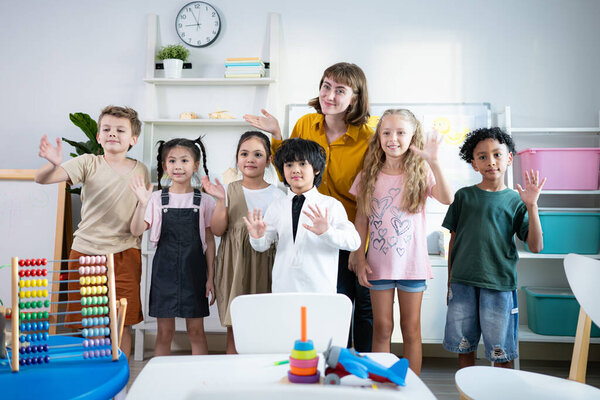 Портрет учителя и детей в классе, где дети получают удовольствие от обучения.