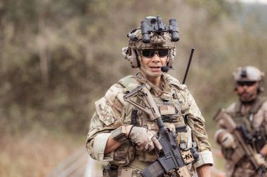 Kamuflaj üniformalı askerler silah taşıyorlar, tropikal orman bölgesinde keşif görevleri, saldırı piyade savaş eğitimi alıyorlar..