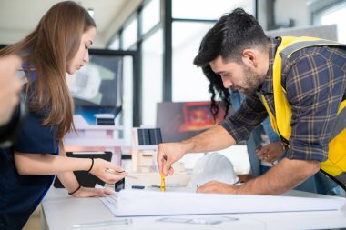 Mühendisler, mimarlar ve tasarımcılar doğal enerji kullanan bir bina tasarlamak için işbirliği yaparlar..
