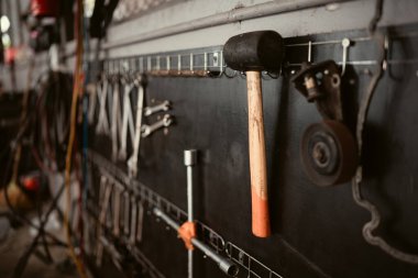 Handyman tools in car repair shop, Close-up of hammer and wrench clipart