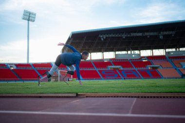 Athletes with disabilities take a break at the stadium between training sessions. clipart