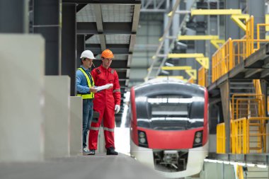 Elektrikli tren tamir atölyesine park edildikten sonra, elektrikli tren mühendisi ve teknisyeni, denetim turuna uygun olarak demiryolu ve elektrik trenlerini teftiş ediyor.