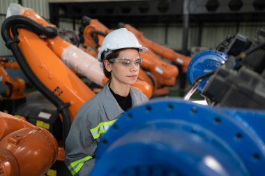 A female auditor Inspected to account for the company's robot assets that were brought to the warehouse before delivering to customers. clipart