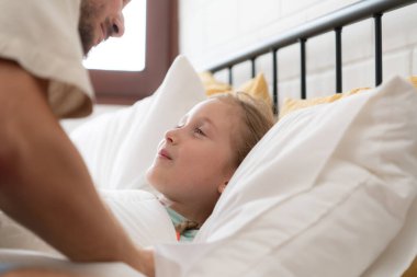 Geceye çekilmeden önce, bir baba sevgisini kızının alnından öperek ifade eder. İyi bir uyku çekmek için.