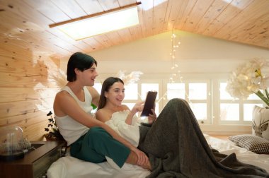 Genç çift sabah yatak odasında birbirlerine halk romanları okuyarak eğleniyor ve eğleniyorlar..