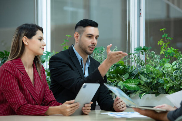 A group of young entrepreneurs. Meeting to exchange opinions and review information to prepare for investing in new stocks related to digital financial business.