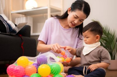 Evde tatildeyken, bir anne küçük bir çocukla ilgilenir.