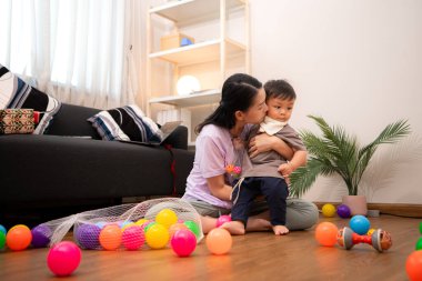 Evde tatildeyken, bir anne küçük bir çocukla ilgilenir.