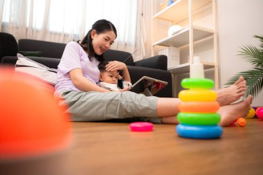 Evde tatildeyken, bir anne küçük bir çocukla ilgilenir.