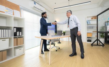 Çağdaş bir ofiste, iki üst düzey yönetici bir iş projesinin ilerleyişini izlemek ve beyin fırtınası yapmak istiyor.