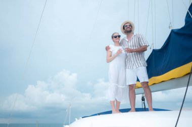 Genç bir çift yatta deniz macerasının tadını çıkarıyor.