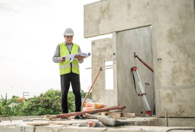 Mühendisler inşaat projelerini denetliyor ve konut binalarının duvarlarının ve temellerinin inşaatını denetliyor ve denetliyor