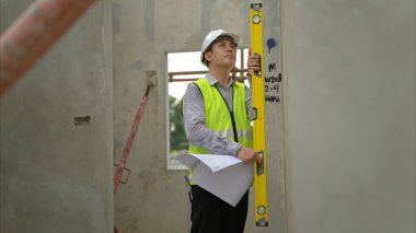 Mühendisler inşaat projelerini denetliyor ve konut binalarının duvarlarının ve temellerinin inşaatını denetliyor ve denetliyor