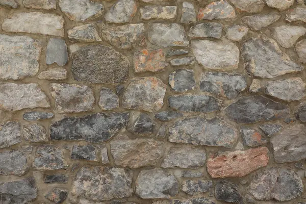 Duvarın dokusunun ve tahılının açıkça görülebildiği granit taşlardan yapılmış taş işçiliği arka plan ve mimari dokular için uygundur..