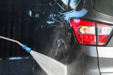 Güneşli bir günde oto yıkama makinesinde yıkama yapmak, self-servis istasyonunda araba yıkamak (oto yıkama serisinin bir kısmı))