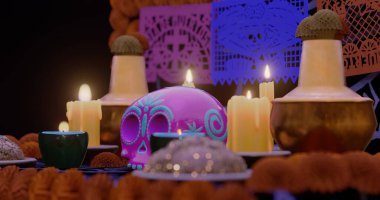 A 3D rendered image depicting a traditional Dia de los Muertos altar. The centerpiece of the scene is a pink sugar skull with decorative patterns, sitting among several lit candles. clipart