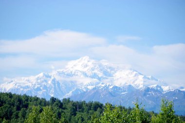 Alaska, Denali Ulusal Parkı 'ndaki eriyen bir buzulun hava görüntüsü çarpıcı mavi eriyen su havuzlarıyla buz ve tortu tabakaları sergiliyor. Görüntü, iklim değişikliğinin devam eden etkilerini ve Alaska buzullarının dönüşümünü vurguluyor