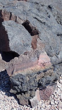 Layers of volcanic rock reveal a spectrum of minerals and cooling processes. This fragmented lava tells the story of past eruptions and the ever-changing landscape of Hawai'i. clipart