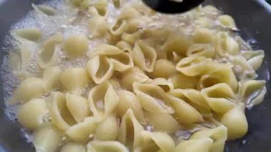 Makarna tavada kaynar suda kaynatıldı. Geleneksel İtalyan makarnası pişirmek. Yüksek kalite 4k görüntü