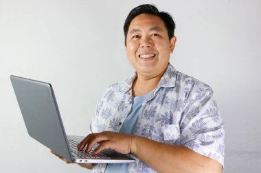 Handsome Smiling Man Working on Laptop clipart