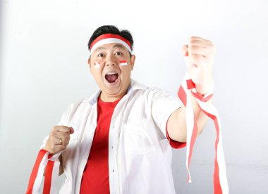 Endonezya bayrağı taşıyan mutlu Endonezyalı adam zaferi kutluyor.