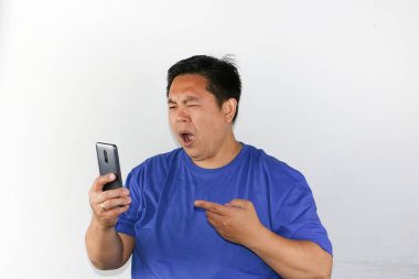 Asyalı adamın akıllı telefonuna baktığı garip bir ifade.