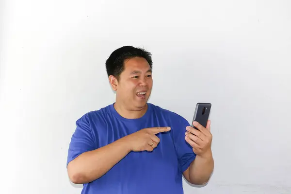 Genç Asyalı adam cep telefonu çalıyor.