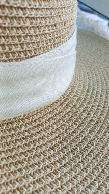 Close-up of a straw hat with woven texture and beige band. Handcrafted sophistication blending classic style with functionality, perfect for sun protection and casual fashion. clipart