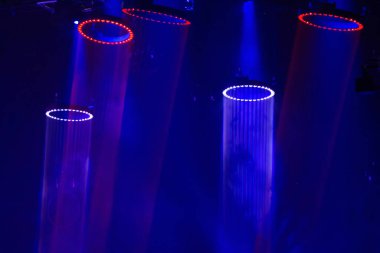 Çoklu dairesel LED ışıkların yer aldığı ışıklandırma, gerçeküstü ve fütüristik bir atmosfer yaratıyor, soyut ve dalgın hissettiriyor, çoğunlukla konserlerde, tekno şovlarda veya modern exhi 'de bulunan bir bilim kurgu ortamını veya yenilikçi görsel sanat kurulumunu andırıyor.