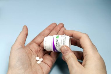 Female hands holding Oxabenz sedative pills. Prescription medication. Copenhagen, Denmark - February 11, 2025 clipart