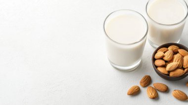 Non-Dairy Vegan Almond Milk Closeup in Glass with Wholesome Nuts Natural Setting clipart