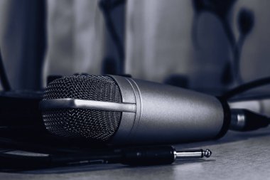 Siyah arka planda kulaklıkları olan mikrofon.