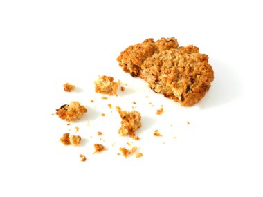 Oatmeal cookie with crumbs isolated on white background 